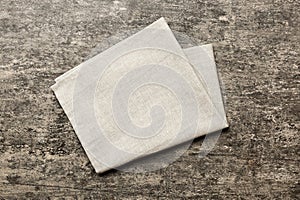 top view with gray kitchen napkin isolated on table background. Folded cloth for mockup with copy space, Flat lay