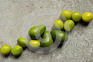 Top view of green avocado, limes