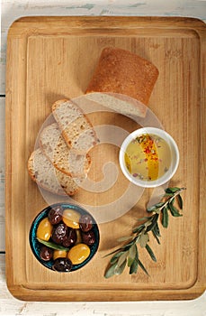 Top view of green and black olives in porcelain bowl with olive