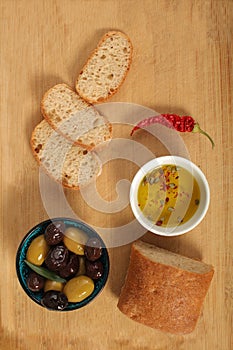 Top view of green and black olives in porcelain bowl with olive