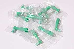 Top View Green Disposable Prophy Angles with Brush, Ergonomic Shape on White Background