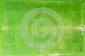 Top view of green grass football stadium or field.