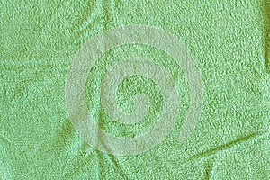 Top view of Green Towel texture. Green Towel Fabric Texture Background. Close-up. Green natural cotton towel background.
