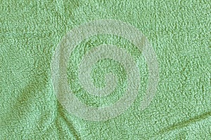 Top view of Green Towel texture. Green Towel Fabric Texture Background. Close-up. Green natural cotton towel background.