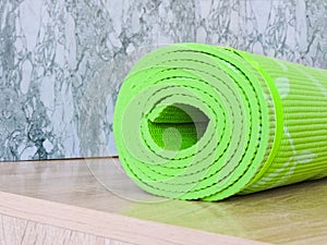 Top view green  yoga mat sport .Rolled up yoga mat isolated on white. Copyspace.