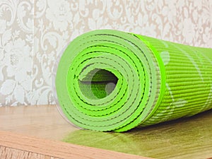 Top view green  yoga mat sport .Rolled up yoga mat isolated on white. Copyspace.