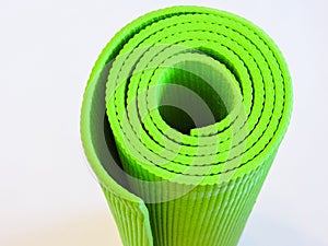 Top view green  yoga mat sport .Rolled up yoga mat isolated on white. Copyspace.