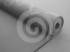 Top view green  yoga mat sport .Rolled up yoga mat isolated on white. Copyspace.