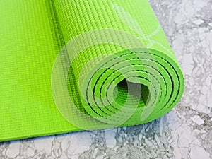 Top view green  yoga mat sport .Rolled up yoga mat isolated on white. Copyspace.