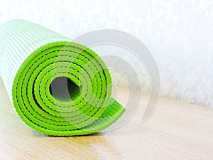 Top view green  yoga mat sport .Rolled up yoga mat isolated on white. Copyspace.