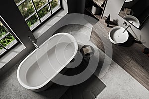 Top view of grey bathroom interior with bathtub, sink and panoramic window