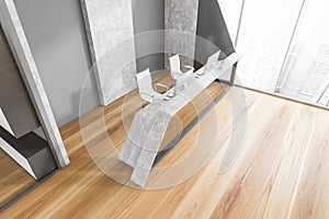 Top view of grey and wooden reception desk with computers near window