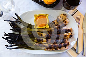 Top view of grilled calcots with romesco sauce