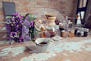 top view of ground coffee pouring water on coffee ground with filter, Flower and brick wall background, Colour Retro style. Copy