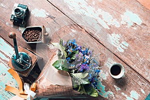 top view of ground coffee pouring water on coffee ground with filter, Flower and wood background, Colour Retro style. Copy space