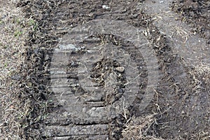 Top view of the ground with tractor wheel tracks, images for outdoor nature background.