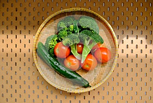 Top view of a group of fresh vegetables produce drying in bamboo sieve after being washed visible water droplets. Beam of