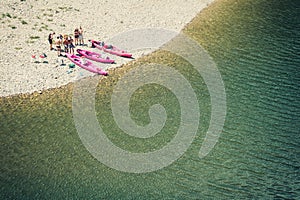 Top view of a group of friends taking a break from canoeing.