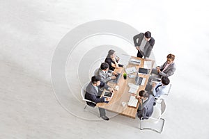 Top view of group of multiethnic busy people working in an office, Aerial view with businessman