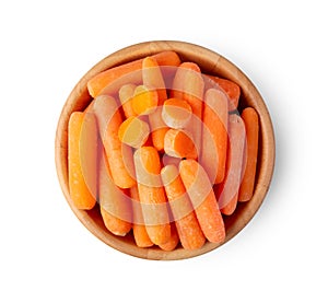 Top view of a group of organic small baby carrots in wood bowl isolated