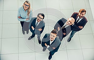 Top view. a group of smiling business people looking at the camera.