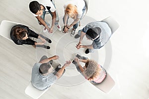 Top view on group of teenagers sitting in a circle during consul photo