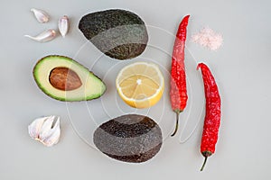 Top view of guacamole ingredients on grey background