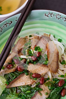 Top view guilin rice noodles with bowl of soup nearby