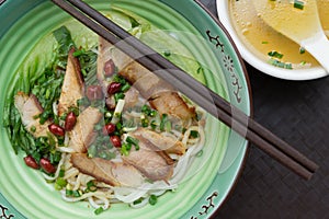 Top view guilin rice noodles with bowl of soup nearby