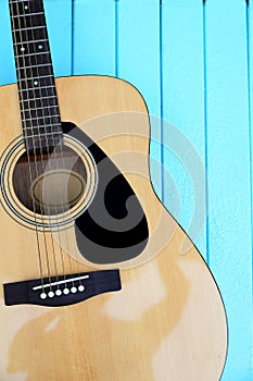 Top view of Guitar on wooden blue background. Summer Holiday or Music concept