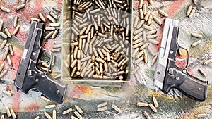 Top view of gun and ammunition box on the table