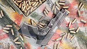 Top view of gun and ammunition box on the table