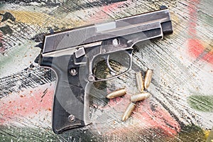 Top view of gun and ammunition on the table photo