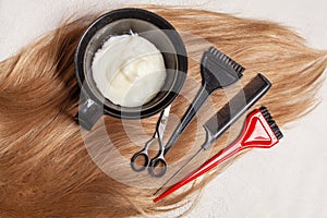Top view of hair, scissors, comb and hair dye, beauty hair salon concept