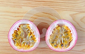 Top View of Half Cut Fresh Ripe Passion Fruits on Wooden Background