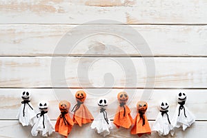 Top view of Halloween crafts, white and orange paper ghost