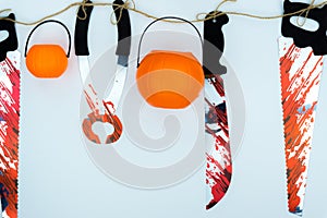 Top view of Halloween decoration, jack o lantern, and bloodstain on the knife and saw on white background with copy space for text