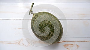top view of hami melon on white wooden table
