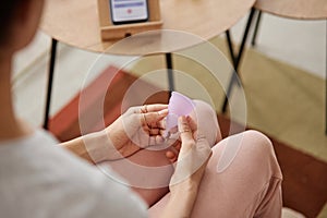 Top View Hand Holding Menstrual Cup