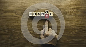 Top view of hand pushing alphabet C to replace E from Change to Chance. Concept of personal development and career growth or
