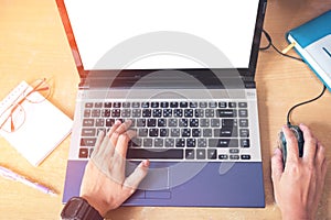 Top view Hand using laptop with blank screen on desk in home