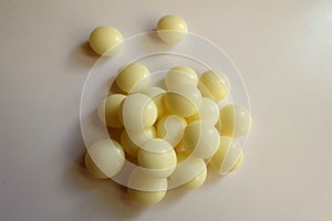 Top view of handful of yellow mints of xylitol