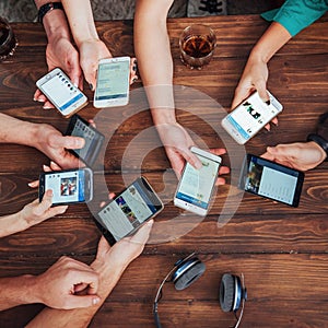 Top view hands circle using phone in cafe - Multiracial friends mobile addicted interior scene from above - Wifi connected people