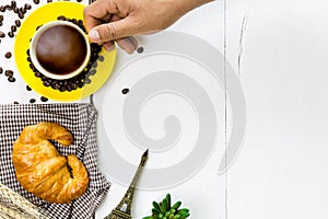 Top view hands of man eating coffee and croissant with coffee be