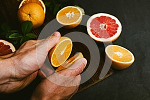 Top view of hands with slices of juicy oranges photo