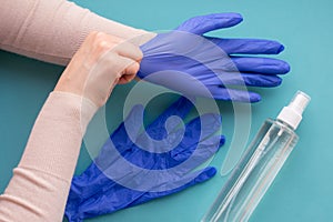 Top view of hands wearing blue medical gloves for protection and self-hygeine