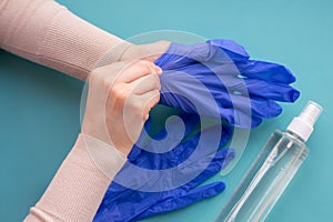 Top view of hands wearing blue medical gloves for protection and self-hygeine