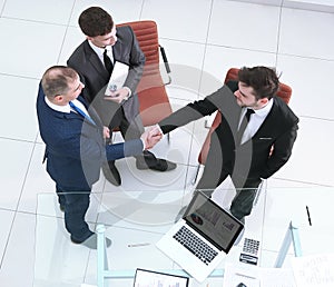 Top view.handshake business partners. the concept of cooperation.
