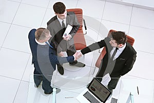 Top view.handshake business partners. the concept of cooperation.
