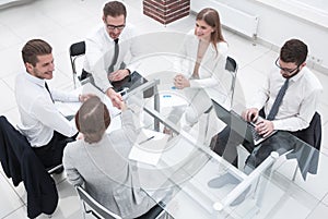 Top view.handshake business partners at the negotiating table.